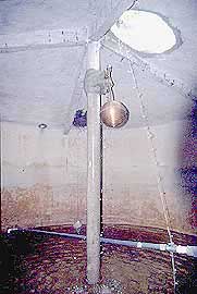 Inside of well-made water storage tank showing outlet level control, float valve.