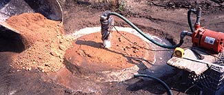 Sealing over the entire top of the dug well area with clay.